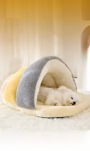 Plush snail-shaped pet bed for cats and small dogs featuring a cozy sleeping Bichon Frise