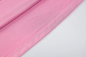 Close-up of pink fabric texture showing high-quality stitching and smooth seam details