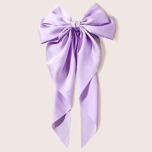 Elegant lavender multi-layer satin bow hair clip with long tassels on cream background