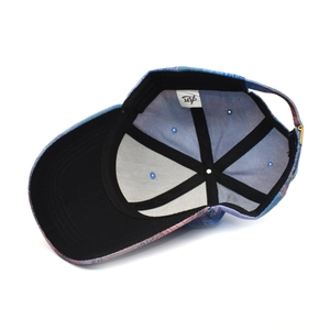 Inside view of tie-dye baseball cap with colorful camo pattern and adjustable metal buckle