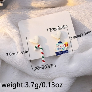 Detail view of asymmetric Christmas snowman and candy cane earrings with size measurements