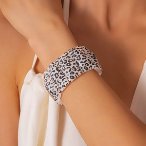 Close-up of leopard print acrylic stretch bracelet showing marbled texture and resin segments