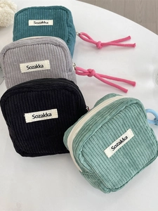 Mini corduroy cosmetic bags in four colors with textured fabric and zipper pulls