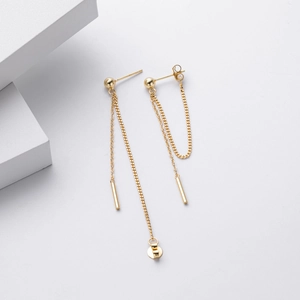 Elegant gold drop earrings with long chain and cylinder pendant on white background