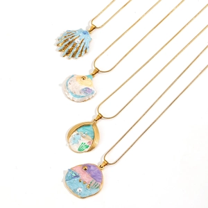 Ocean-themed gold necklaces with shell and beach oil-painted pendants and pearls