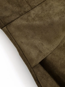 Close-up of deep khaki faux suede fabric texture and fine stitching on asymmetric dress