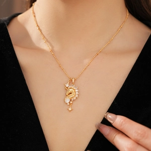 Detail view of 18k gold plated unicorn star necklace with zircon on female collarbone