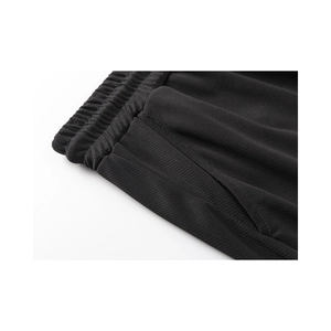 Detail of black breathable mesh gym shorts with elastic waist and side pocket