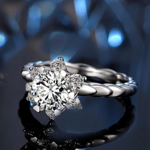 Macro shot of silver ring with snowflake diamond setting and woven texture band
