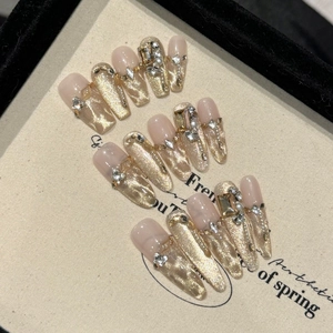 Macro view of luxury cat-eye press-on nails with 3D rhinestones and pearl accents