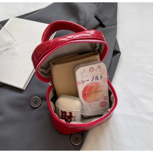 Overhead view showing the spacious interior and red quilted texture of this handbag