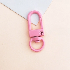 Detailed view of candy pink painted metal lobster clasp hook for DIY keychains and bags