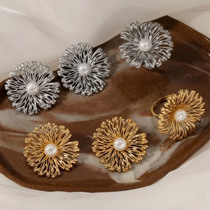 Daisy flower jewelry set with pearls in gold and silver finish on marble tray