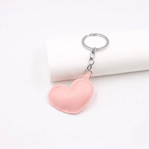 Pink heart PU leather keychain accessory with silver metal ring on white background