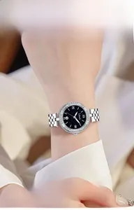 Close-up of a women's starry sky watch with blue sandstone dial and diamond-set bezel