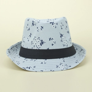 Close-up of light blue straw sun hat with navy floral print and black ribbon band