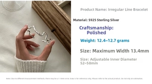 Detail of S925 sterling silver open bangle with wavy texture and polished finish details