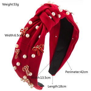 Red knotted fabric headband with pearls and metallic bow charm, shown with dimensions