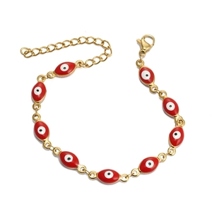 Detail view of gold-plated evil eye bracelet showing red enamel and lobster clasp