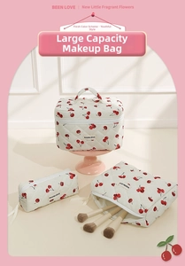 Three-piece quilted white makeup bag set with red cherry patterns and ribbon zippers