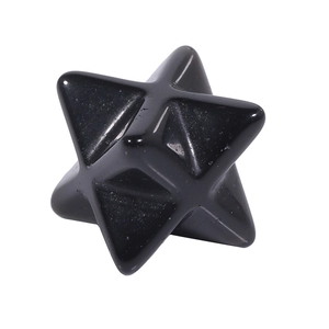 Macro shot of polished black obsidian Merkaba star stone with smooth geometric surfaces