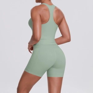 Rear view of a sage green racerback tank top and high-waist shorts yoga set for women