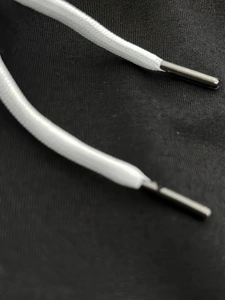 Detailed close-up of white woven drawstring featuring premium gunmetal metal tips