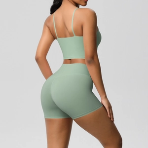 Detail view of mint green high-waist yoga shorts and strapless back sports bra set