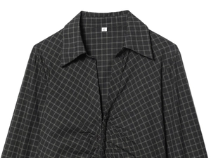 Detail of ruched front and plaid pattern on black and grey slim-fit long sleeve shirt