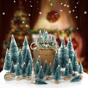 Mini sisal Christmas trees in teal with white snow effect and wooden bases detail