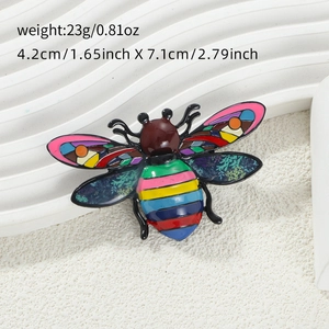 Close-up of colorful winged insect enamel brooch showing dimensions and alloy texture