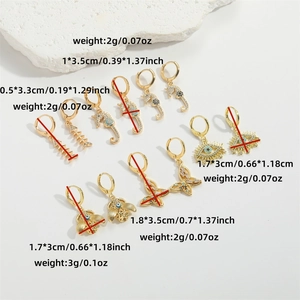 Golden sea animal earrings set with fishbone and seahorse charms and sizing details