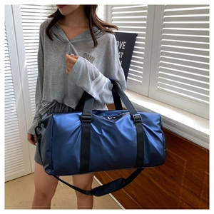 Detail of dark blue travel bag with luggage sleeve and adjustable shoulder straps