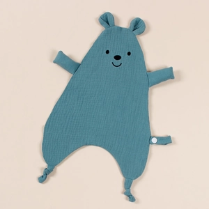 Detailed close-up of blue muslin cotton baby comforter with embroidered bear face features