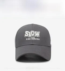 Detailed embroidery on dark grey baseball cap featuring SLOW LIFE TO SEE A WORLD text