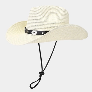 Detail of cream straw cowboy hat featuring silver studs on black band with chin strap