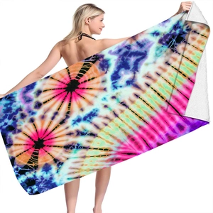 Detail showing vivid tie-dye microfiber beach towel with reinforced edge stitching
