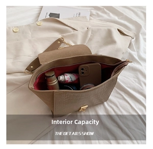 Detail showing the spacious interior of the brown crocodile pattern wing bag