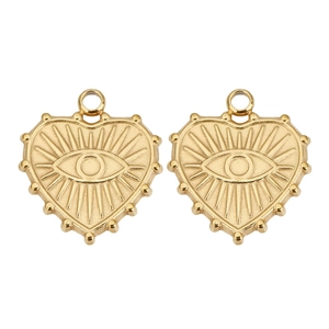 Close-up of two gold heart charms with evil eye engraving and beaded edge details