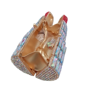 Lipstick shaped evening clutch bag with iridescent rhinestones and gold chain strap