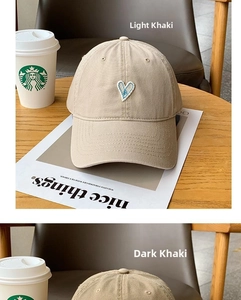 Close-up of heart embroidery on light and dark khaki cotton baseball caps