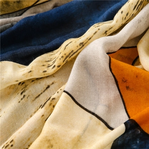 Detailed macro view showing the geometric leopard print texture on a sheer summer scarf