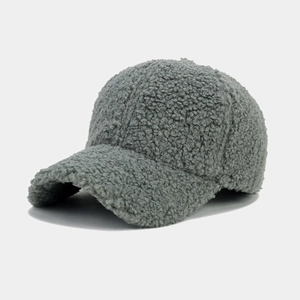 Close-up of thick textured gray lamb wool fabric on a minimalist baseball cap