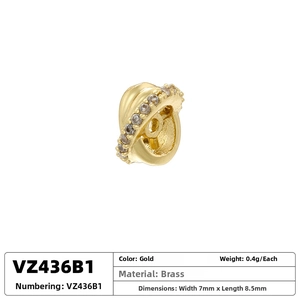 Macro detail of gold plated brass planet spacer bead with sparkling cubic zirconia inlay