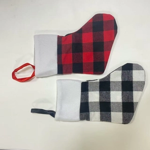 Detail of red and black buffalo plaid Christmas stockings with white faux fur cuffs
