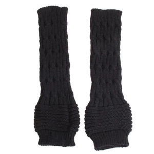 Close-up of black knitted arm warmers with twisted cable patterns and ribbed cuffs