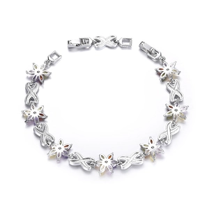 Detail view of silver floral bracelet with purple, red, and blue marquise cut stones