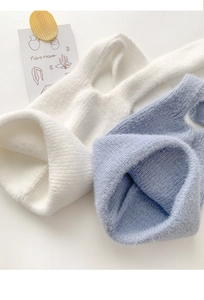 Detailed close-up showing soft knit texture and rabbit ear design in white and light blue
