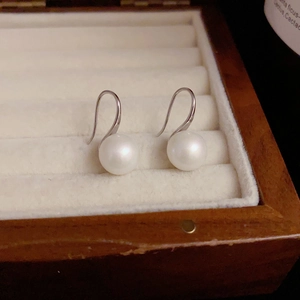 Boucles d'oreilles élégantes en argent 999 avec perles d'eau douce blanches sur écrin à bijoux
