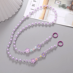 Detail of purple and clear floral beads lanyard with metallic clasps on a clean background